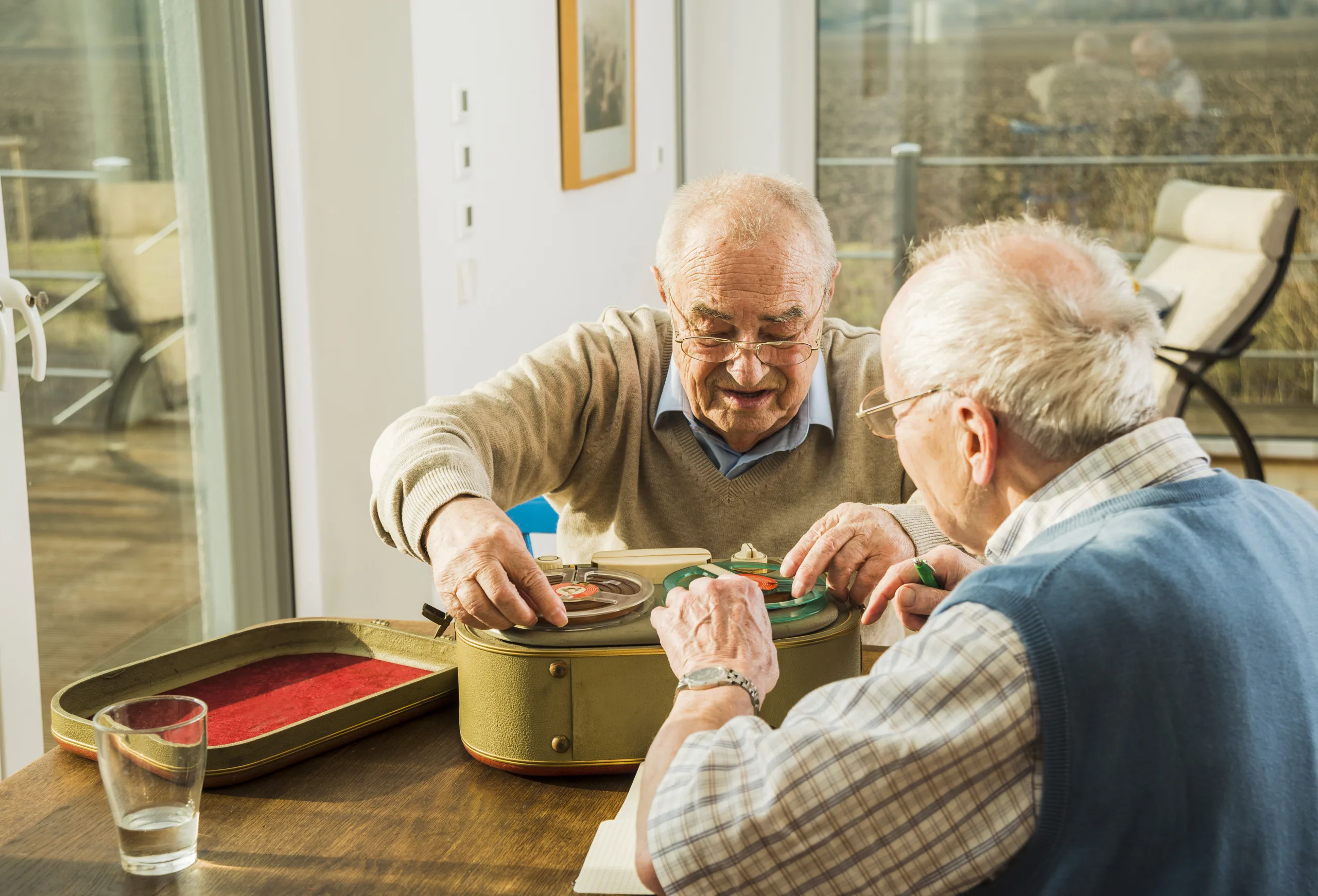 Two senior friends with old-fashioned recorder